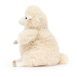 A fluffy cream sheep cuddly toy from Jellycat. sitting down with a curly fluffy coat and a cream cute face