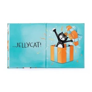 The hardback book is open on a double spread page showing a jellycat black and white cat bursting from an orange gift box