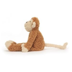 A monkey soft toy from Jellycat with a toffee brown body and pale peach face, hands, feet and tail and a cute face
