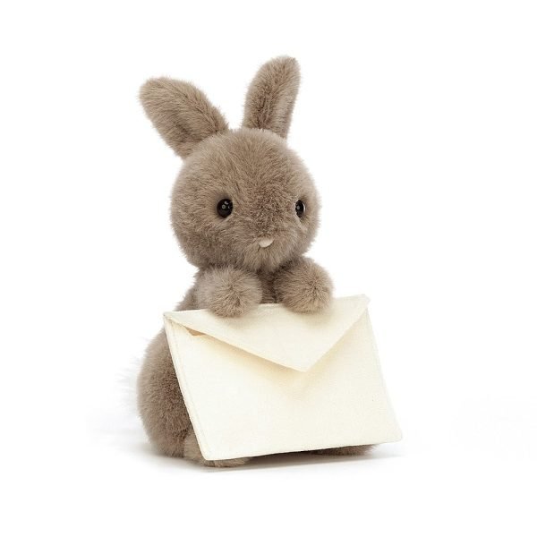 A brown fluffy bunny holding a cream envelope with a card inside. Soft toy from Jellycat