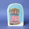 A birthday card with a pink cake on a blue background. there are 30 candles on the cake and 30 today on the front of the cake