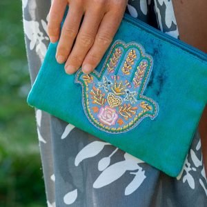 Rich teal velvet purse with embroidered and embellished hand of Fatima and a golden tassel zip