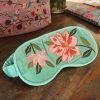 Turquoise velvet sleep mask with elasticated satin head strap and pretty pink floral embroidery