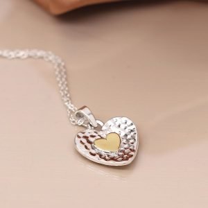 Sterling silver fine chain necklace with a hammered heart shaped pendant, featuring a brass heart inlay