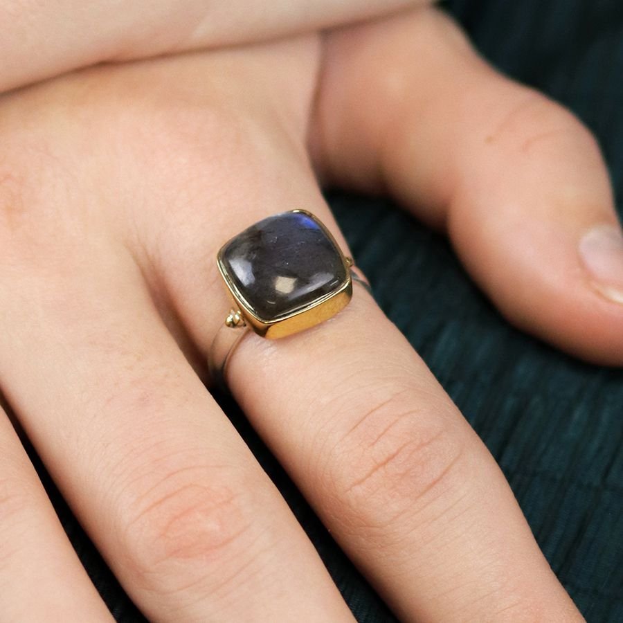 Sterling silver ring with a fine band and a large quare labradorite cabochon, in a brass plated setting