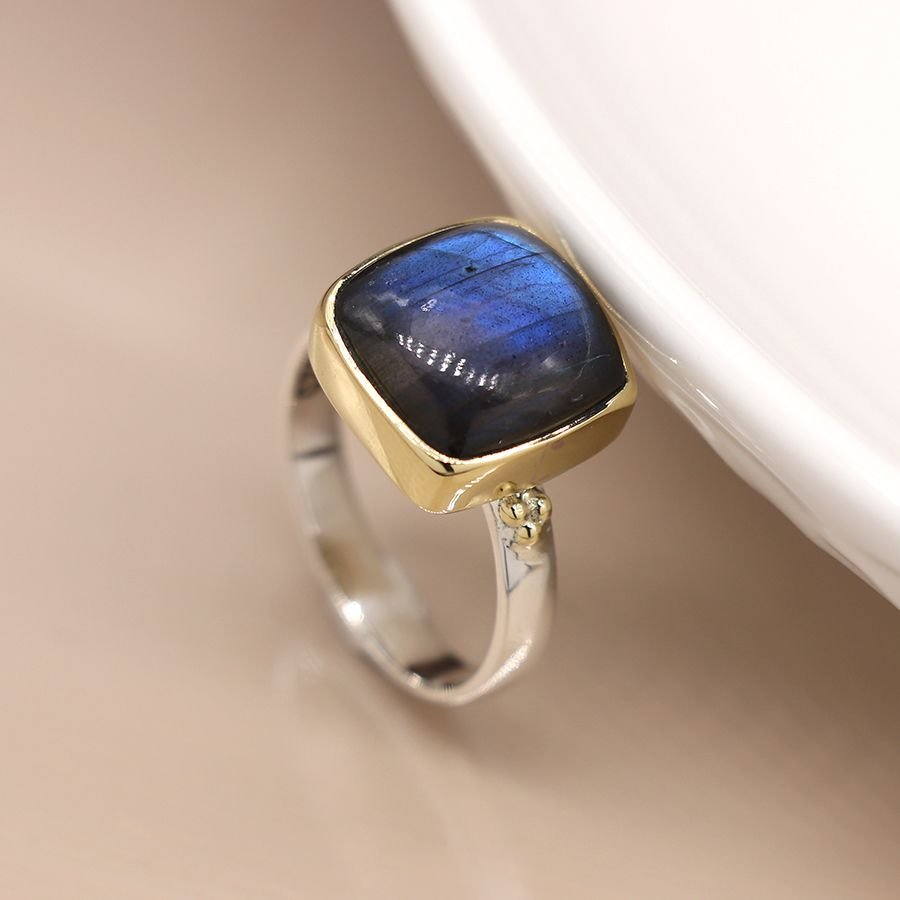 Sterling silver ring with a fine band and a large quare labradorite cabochon, in a brass plated setting