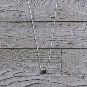 A mix of patinated brass and steel nuts strung on an 18″ silver plated snake chain