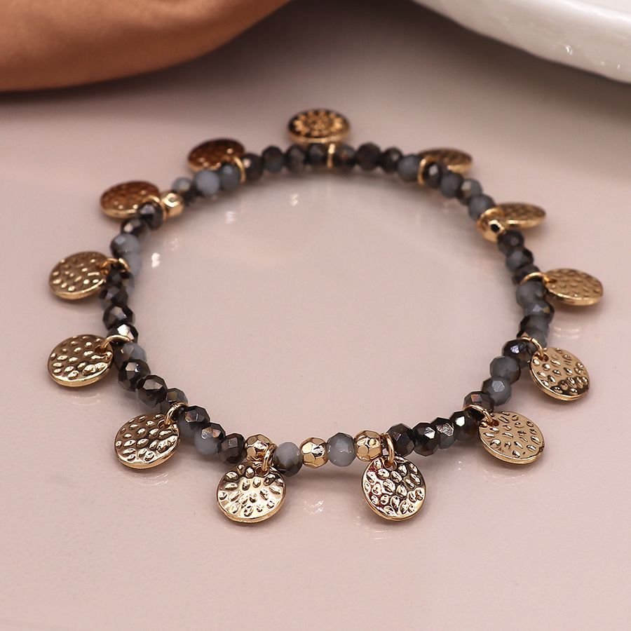 Black and grey mix bead bracelet with hammered disc charms and POM flower tag