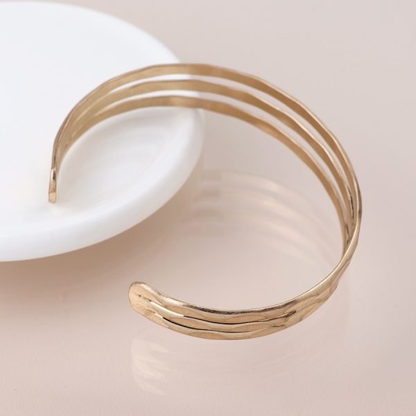 Golden worn hammered triple strand bangle