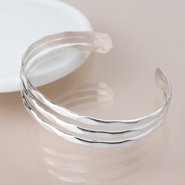 Silver worn hammered triple strand bangle